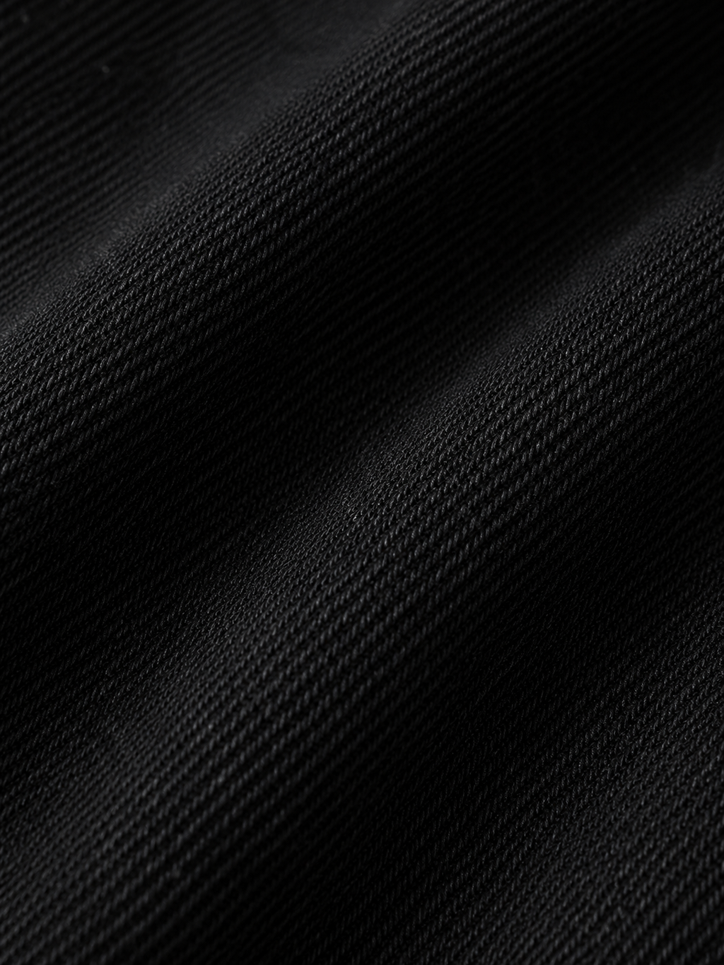The Cropped Denim Jacket Textured_folds_of_black_fabric
