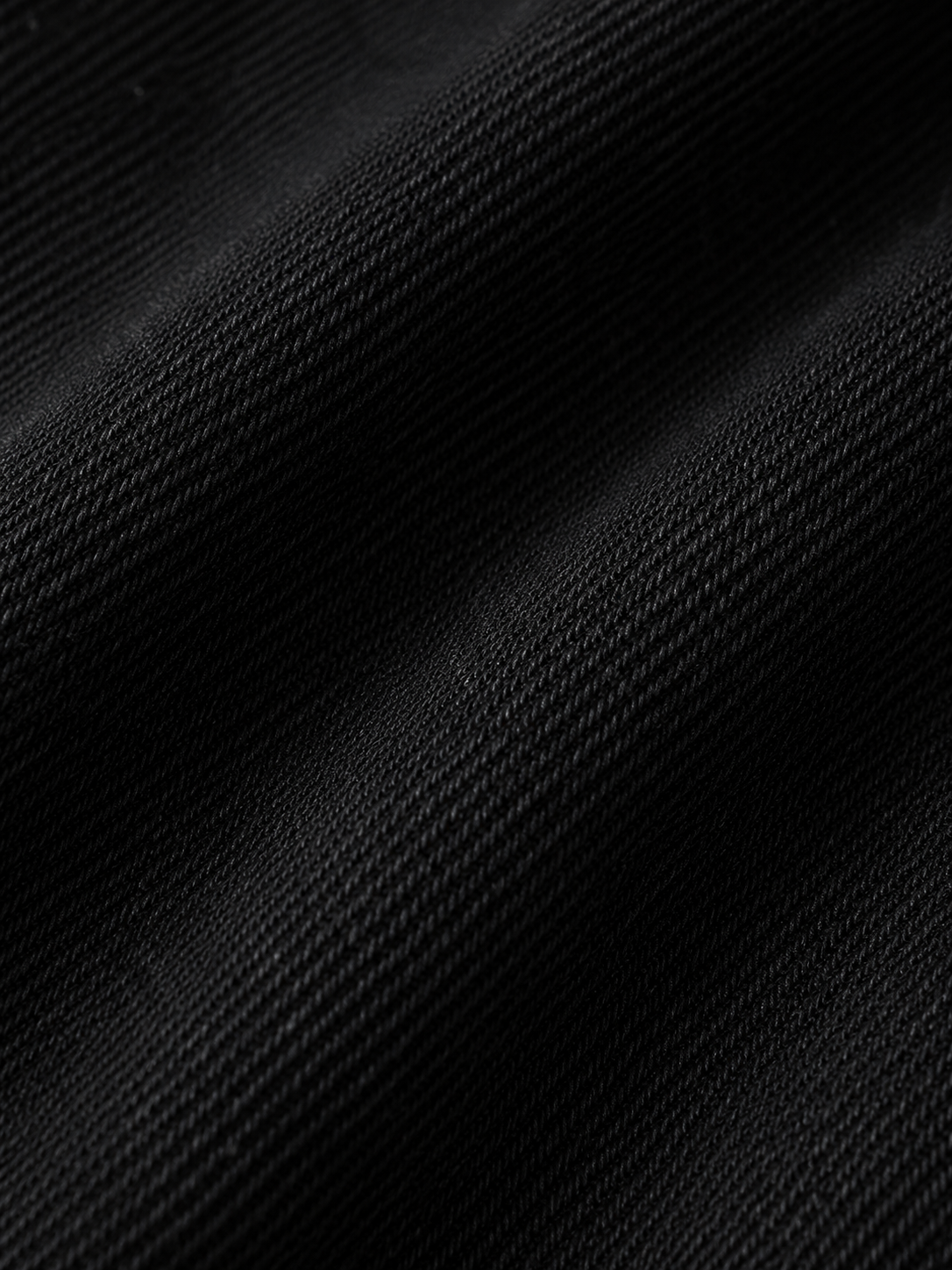 The Cropped Denim Jacket Textured_folds_of_black_fabric